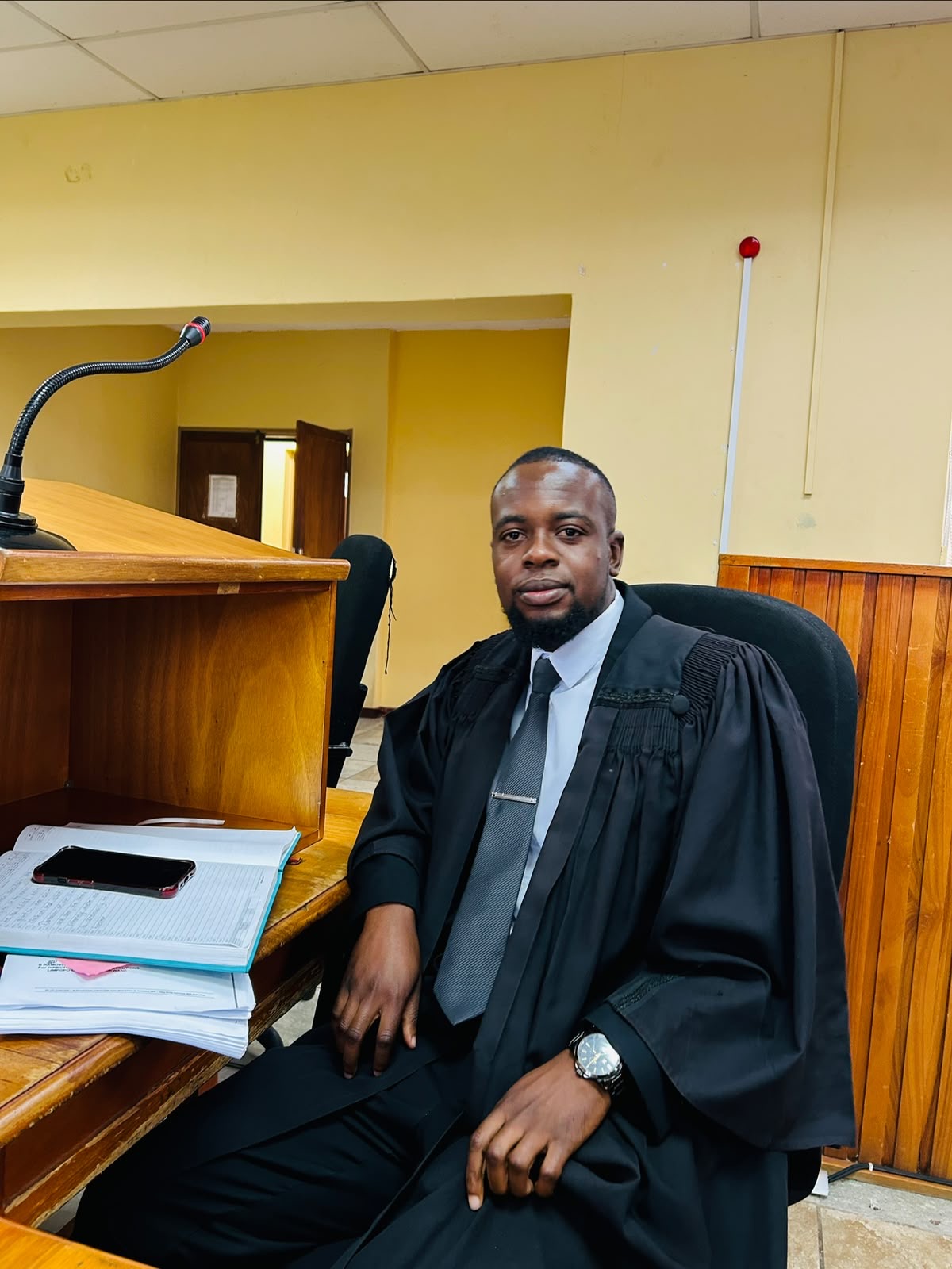 Legal practitioner seated in a courtroom